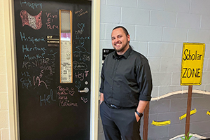 Teacher Steven Lewis at his classroom door at HSA at Monroe Middle